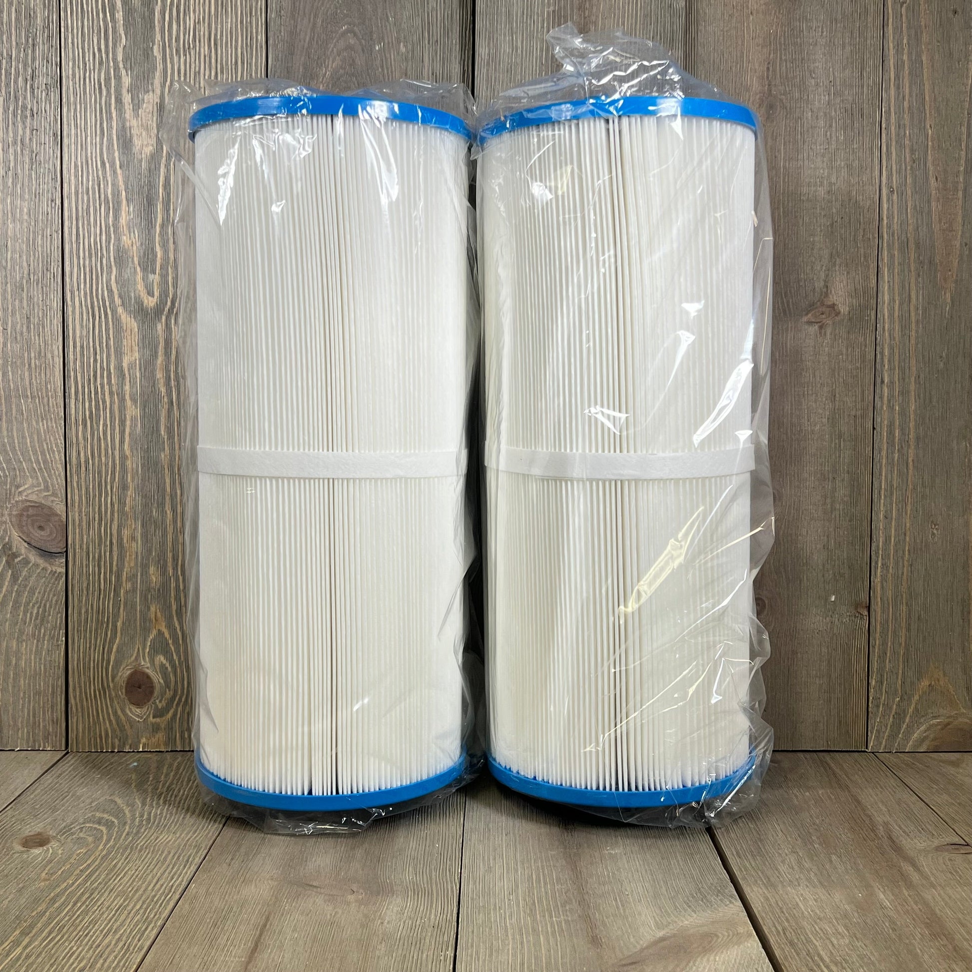 Two-pack Jacuzzi spa filter replacements, model 1047177217-JIOTAR 14081, sealed in plastic on a wooden surface.