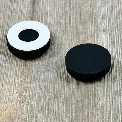 Black magnetic silicone curtain weights on wood, ideal for bathroom decor and outdoor use, in a 12 pack with carrying case.