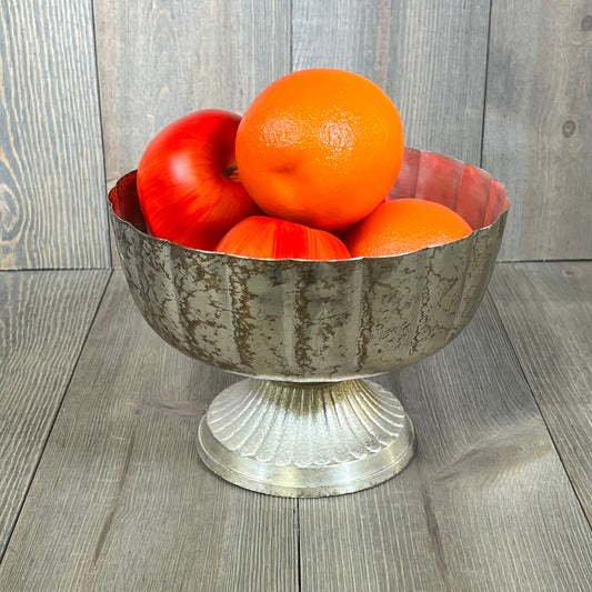 Distressed champagne metal compote bowl filled with vibrant oranges and apples, perfect for indoor or outdoor events.