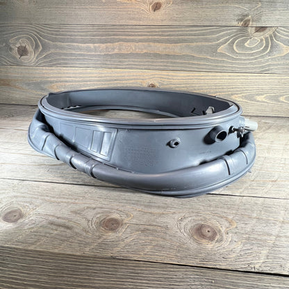 Waterproof door boot gasket for Samsung washer, front load replacement, part DC97-18094B shown on wooden surface.