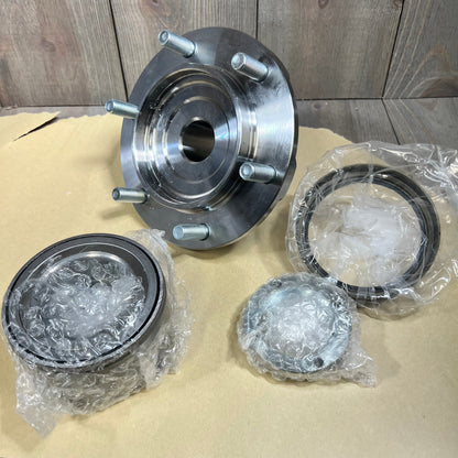 Wheel hub bearing kit for Toyota Tundra and Tacoma, showing components on a wooden background.
