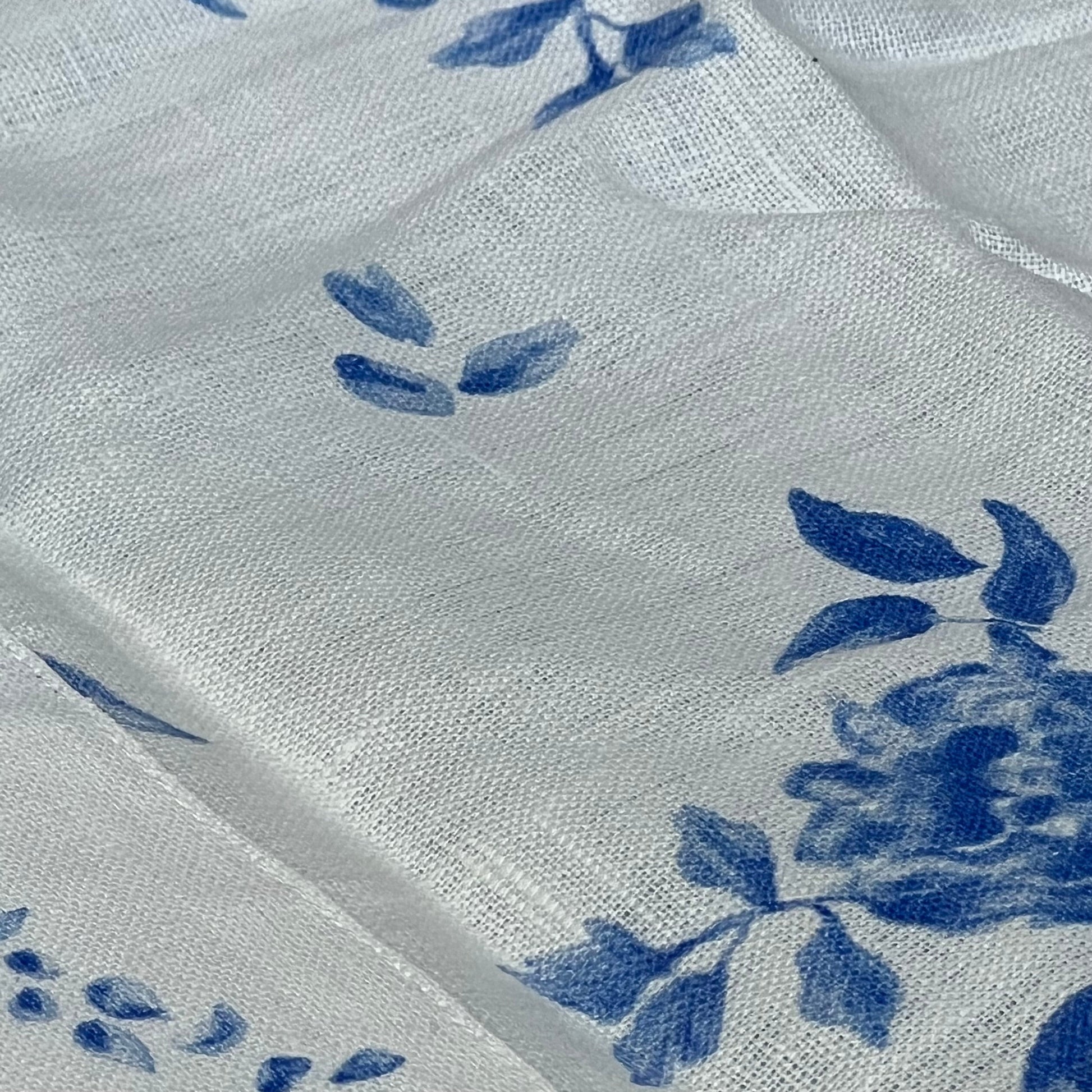 Blue floral linen table runner detail, showcasing handcrafted Jolie Fleur print on 100% pure linen, perfect for summer decor.