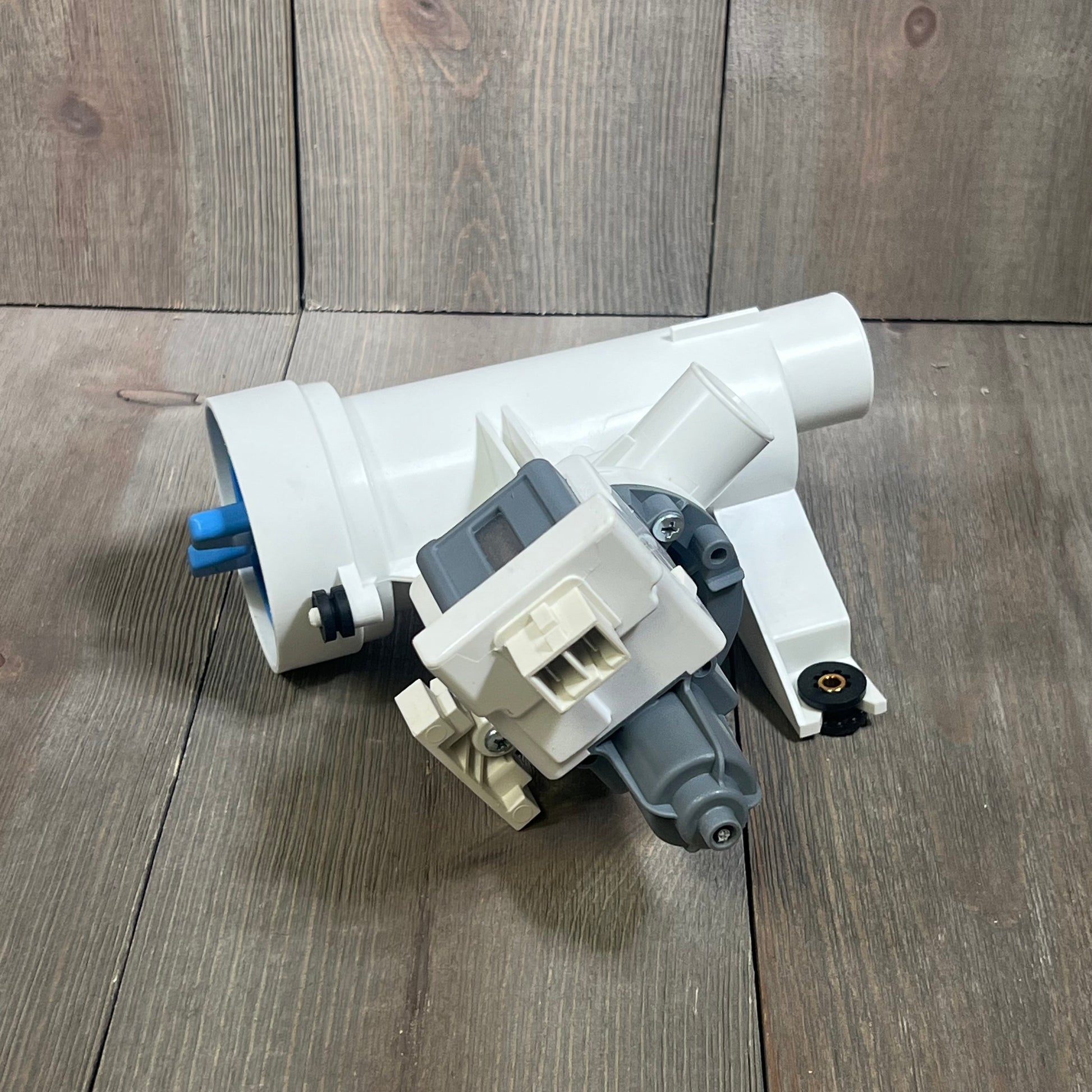 Efficient GE washer drain pump with filter, model WH11X29539, replacement part for washing machines, white casing.