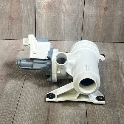 White washer drain pump and filter for GE washing machines, model WH11X29539, shown on a wooden surface.