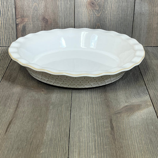Elegant 9-inch stoneware pie dish with embossed design, perfect for baking apple pies, quiches, and tarts.