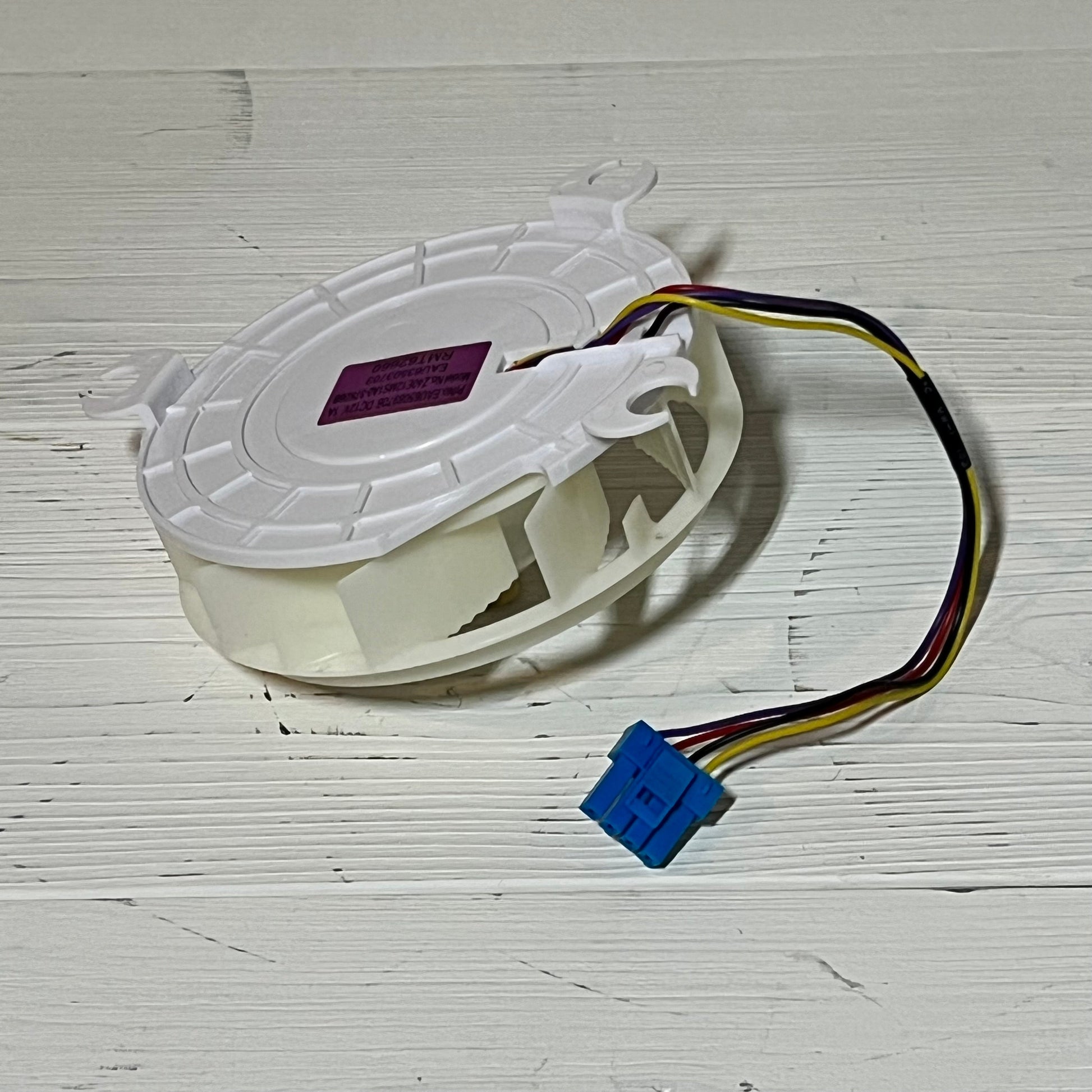 Refrigerator evaporator fan motor assembly with wiring, compatible with LG models, enhances cooling efficiency.