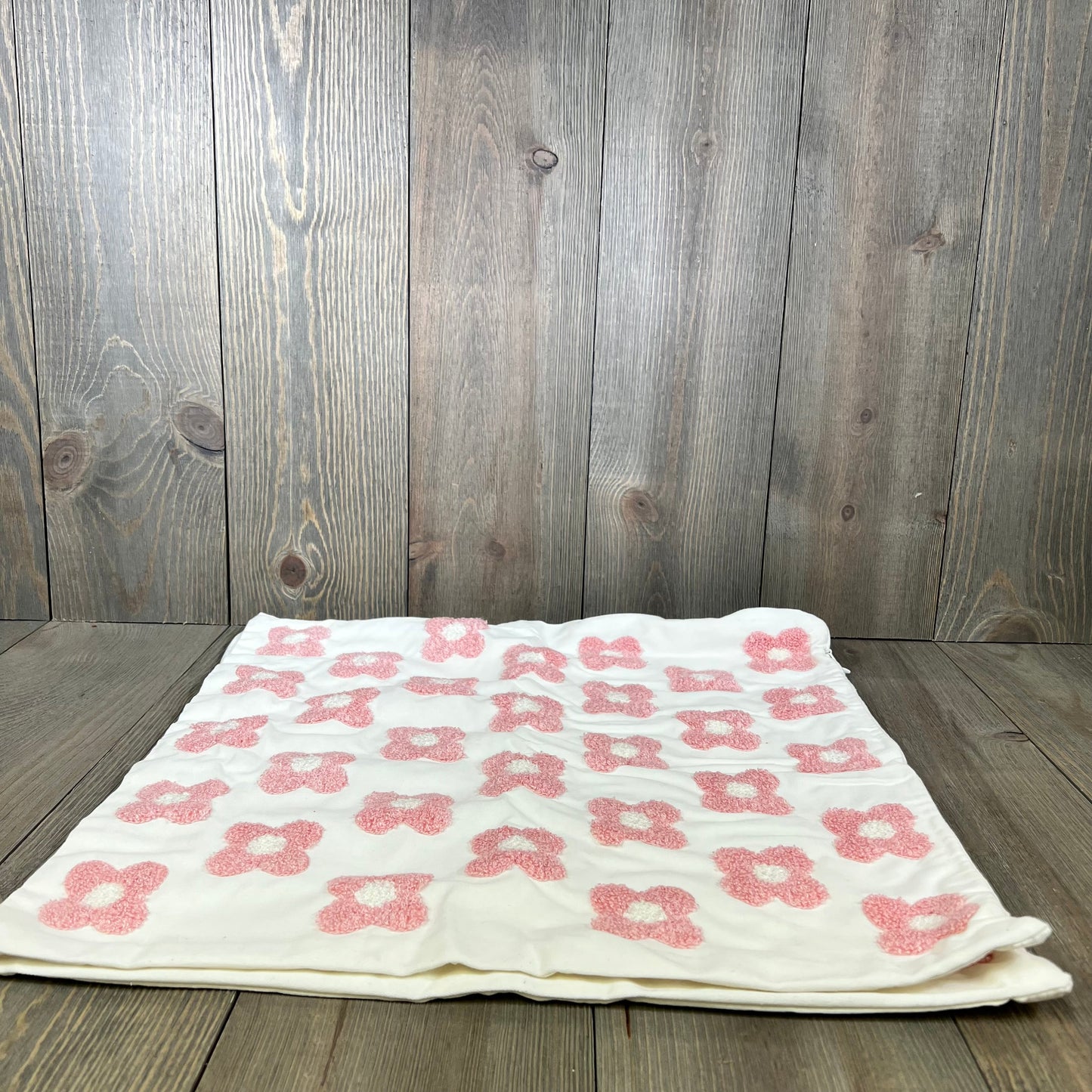 Pink and white daisy sunflower jacquard pillow cover on wooden background, perfect for couch or bed decor.