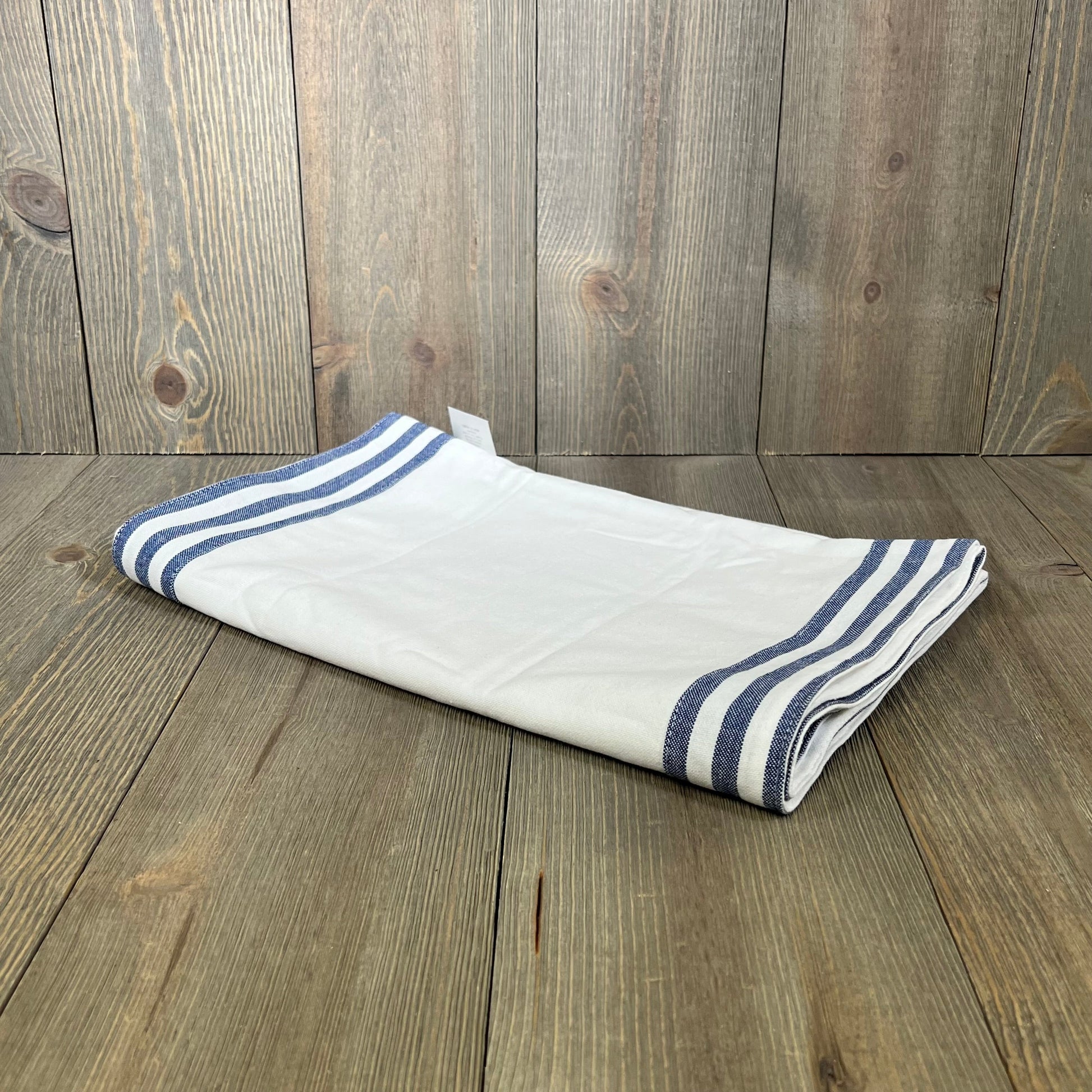 White cotton table runner with blue stripe edges, 72 inches long, adds elegance to spring and summer decor. Durable and washable.