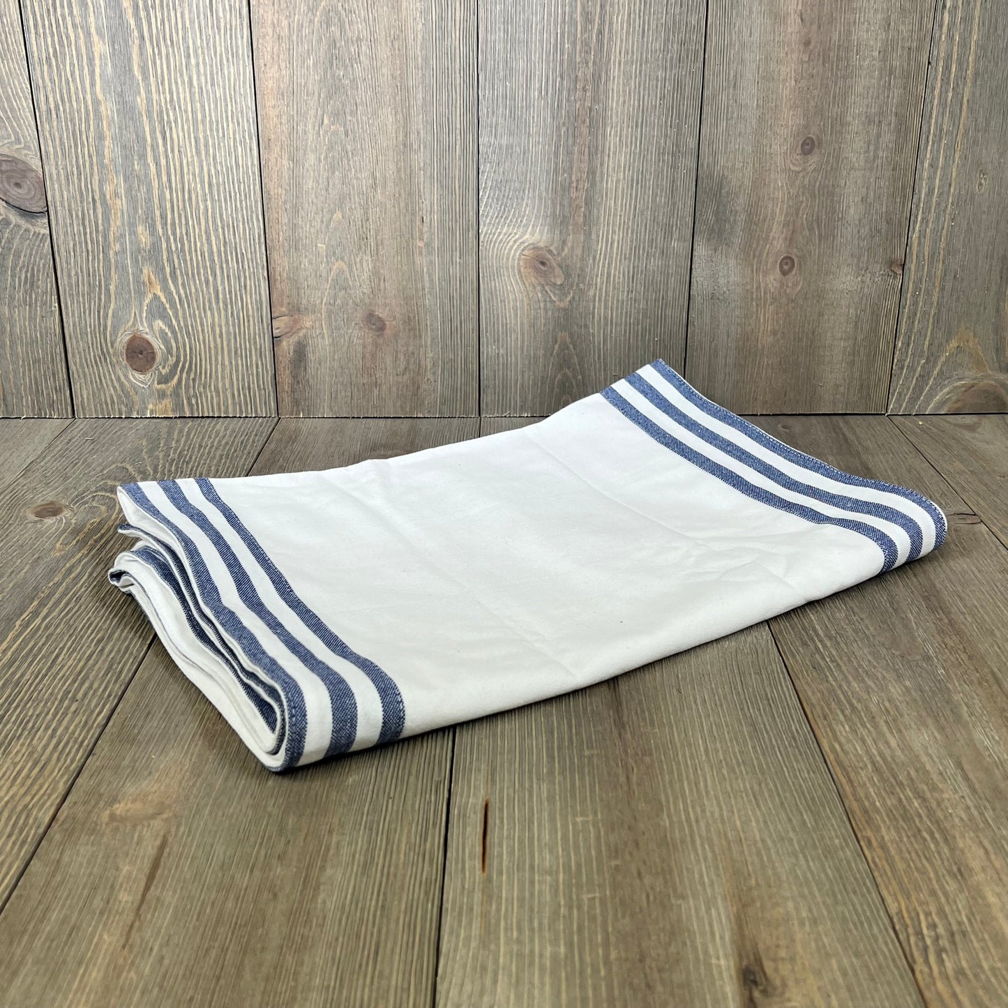 White cotton table runner with blue striped edges, 72 inches long, perfect for spring and summer decor.