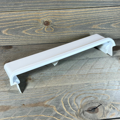 White Frigidaire 241511706 refrigerator door shelf bin on wooden surface, ideal for adding extra storage space.