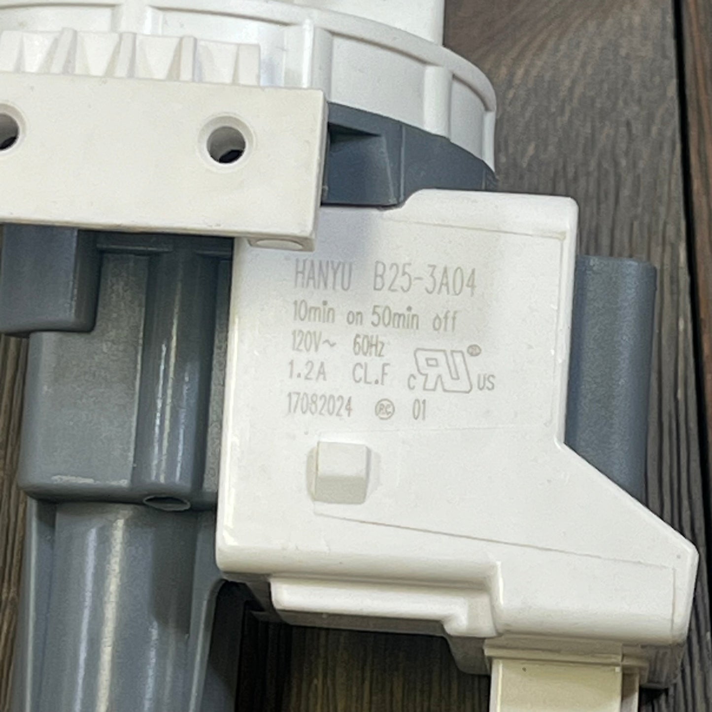 Close-up of GE washer drain pump and filter, model WH11X29539, showcasing detailed specifications.