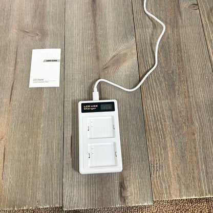 LCD dual charger for Arlo Pro batteries with USB-C cable on wooden surface, includes user guide.