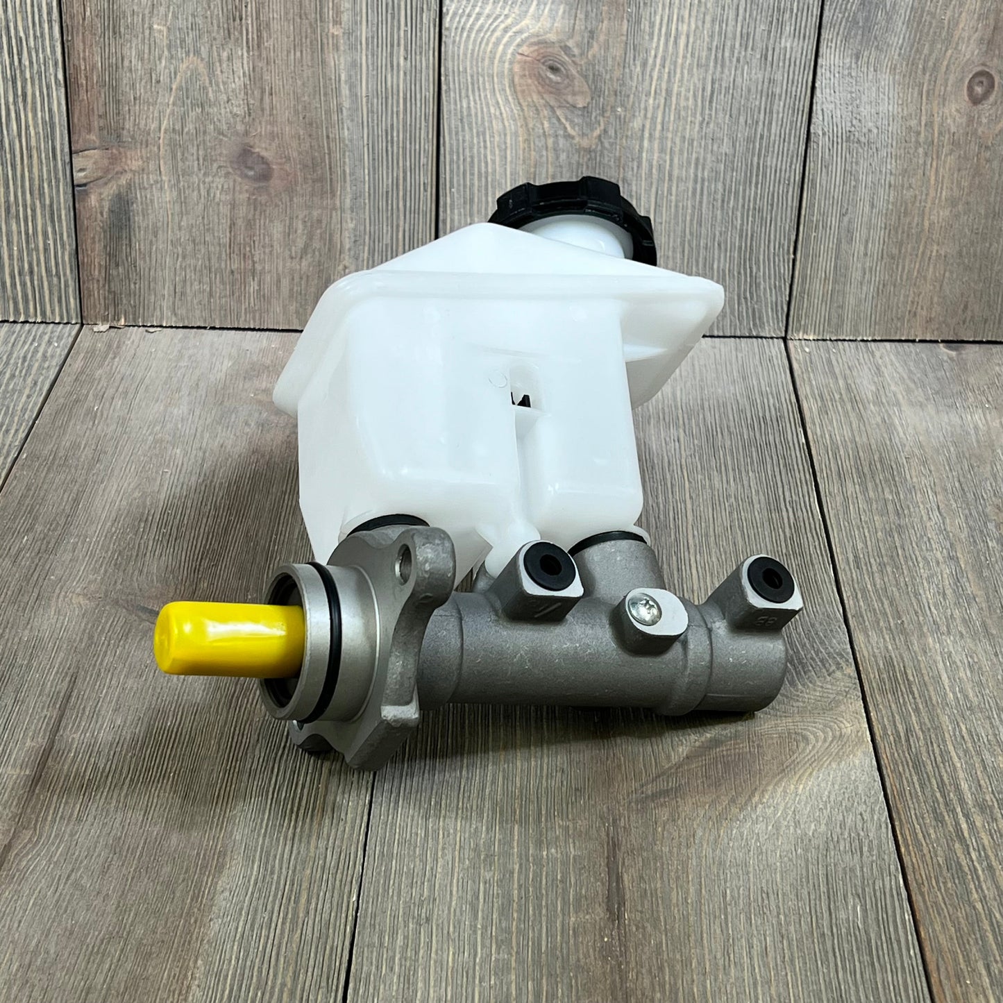 Silver and white TUCKBOLD Brake Master Cylinder for Kia Rio 2006-2011, featuring a durable hydraulic design with reservoir.