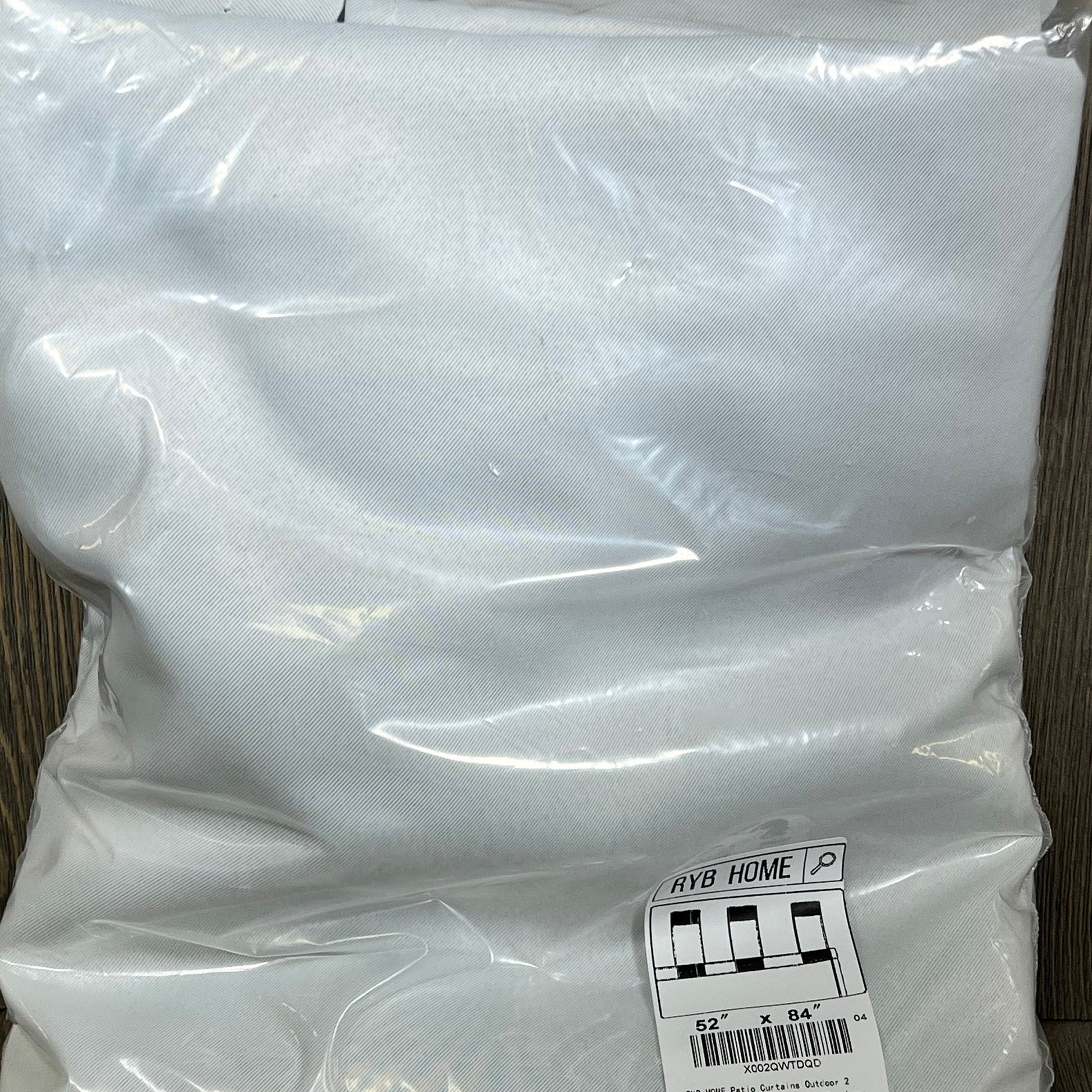Greyish white RYB HOME patio curtains in packaging, waterproof and blackout, size 52x84 inches, perfect for outdoor use.