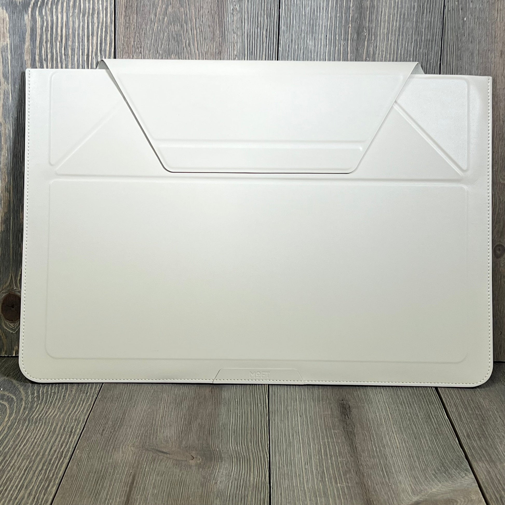 Ultra-slim MOFT laptop sleeve in beach white, designed for MacBook, featuring expandable storage and adjustable stands.