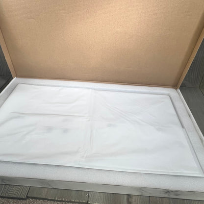 Grey Infinity stone bath mat packaged in an open box, showcasing its smooth, non-slip surface ideal for quick drying.