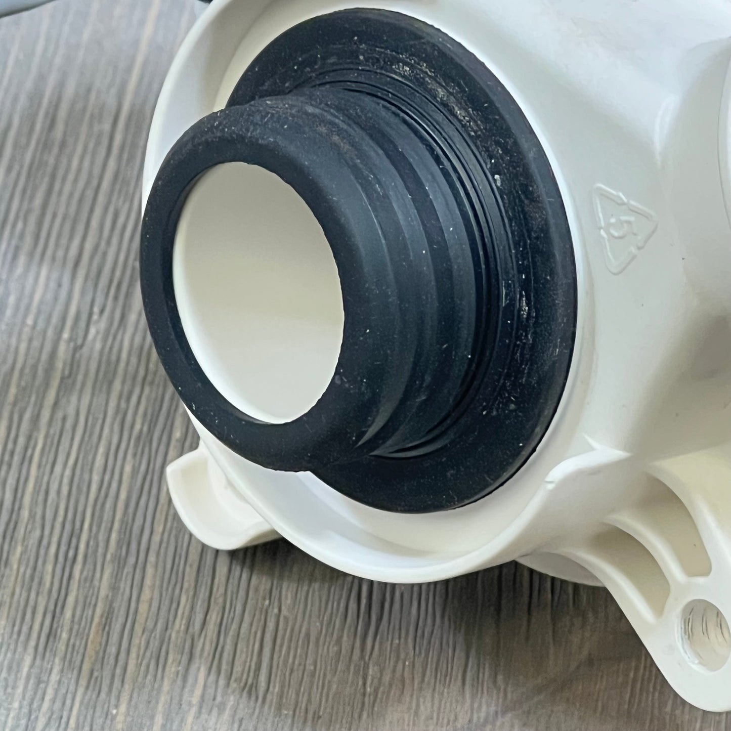 Close-up of Yendse WH23X28418 drain pump motor for Hotpoint GE washer, showing durable rubber and plastic components.