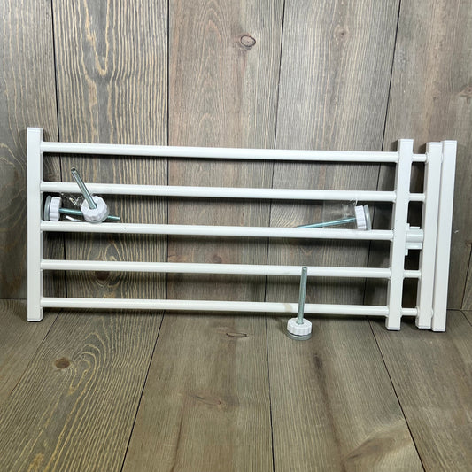 White metal indoor dog gate with pressure mount, perfect for stairs and doorways, adjustable 26-41 inches wide, 10 inches tall.