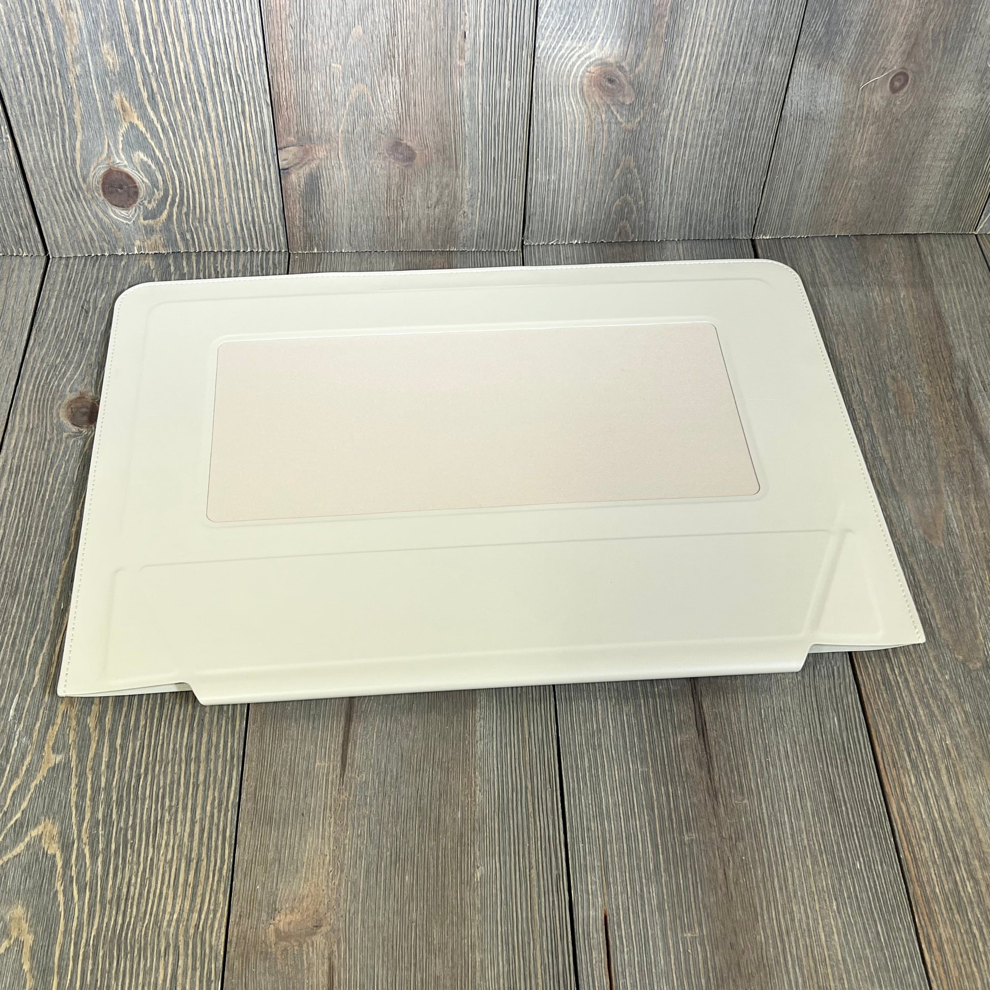 Ultra-slim MOFT Beach White laptop sleeve bag with expandable storage, designed for 15"-16" MacBook, on wooden background.