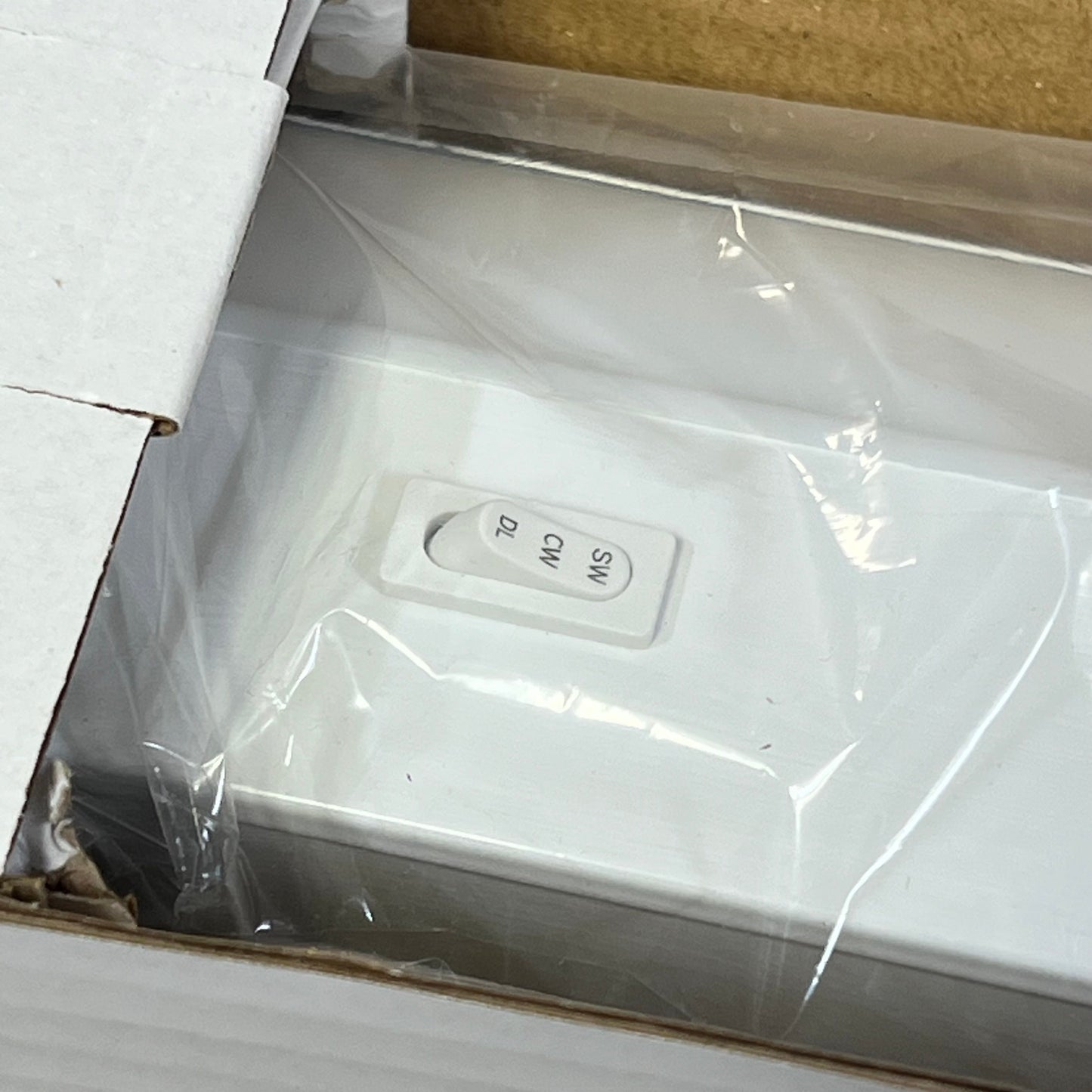 Under cabinet light switch close-up, showing 3 color settings: 2700K, 4000K, 5000K for customizable kitchen lighting.
