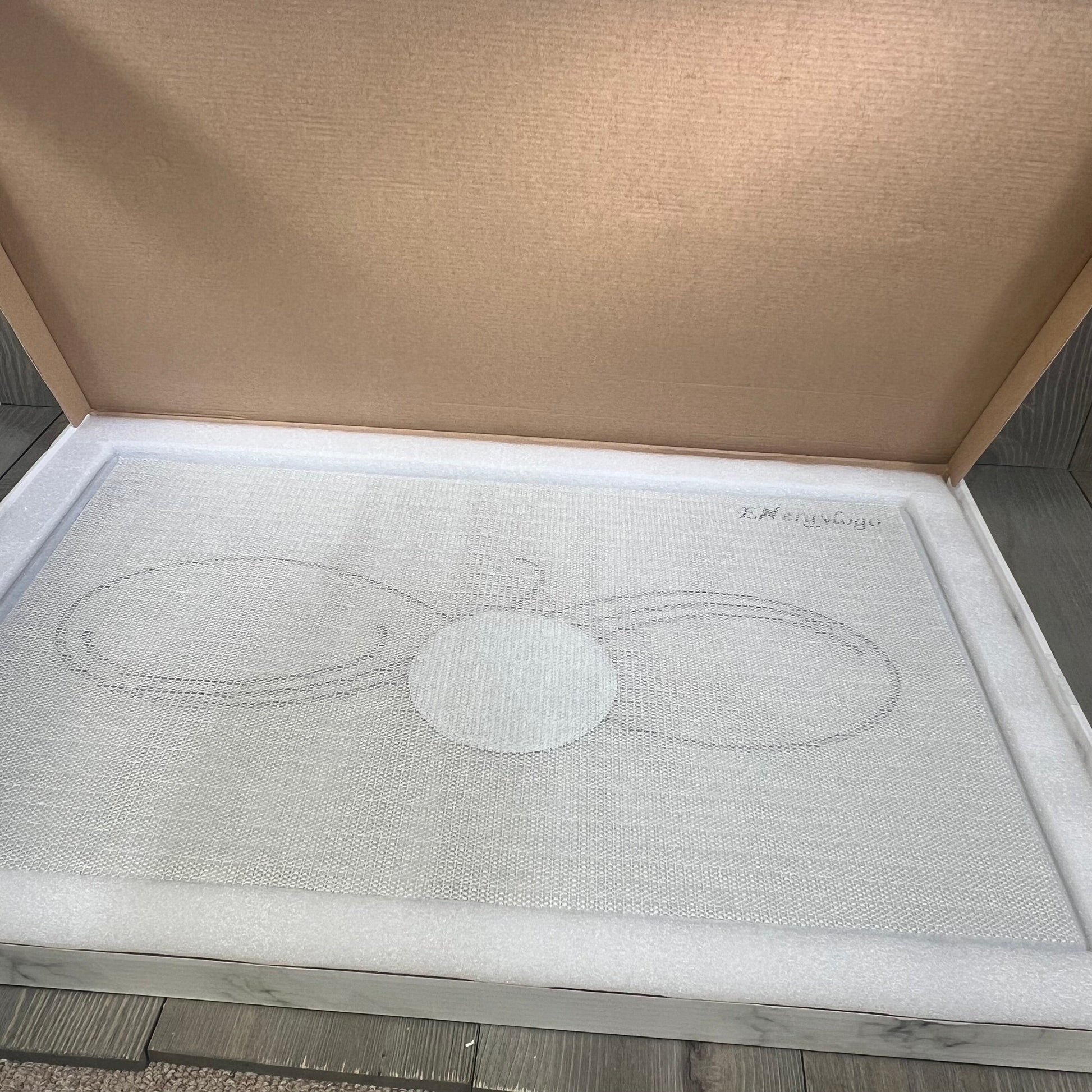 Grey Infinity stone bath mat in packaging, showcasing non-slip, quick-drying diatomaceous earth design for bathroom floors.