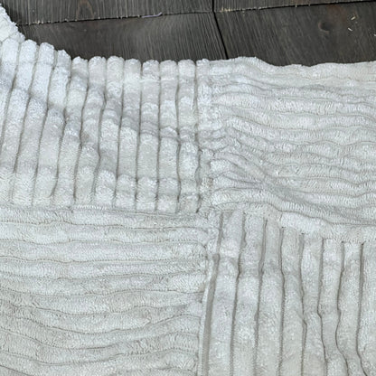 Cream decorative throw pillow cover with soft corduroy texture, featuring a cross patchwork design for rustic boho decor.