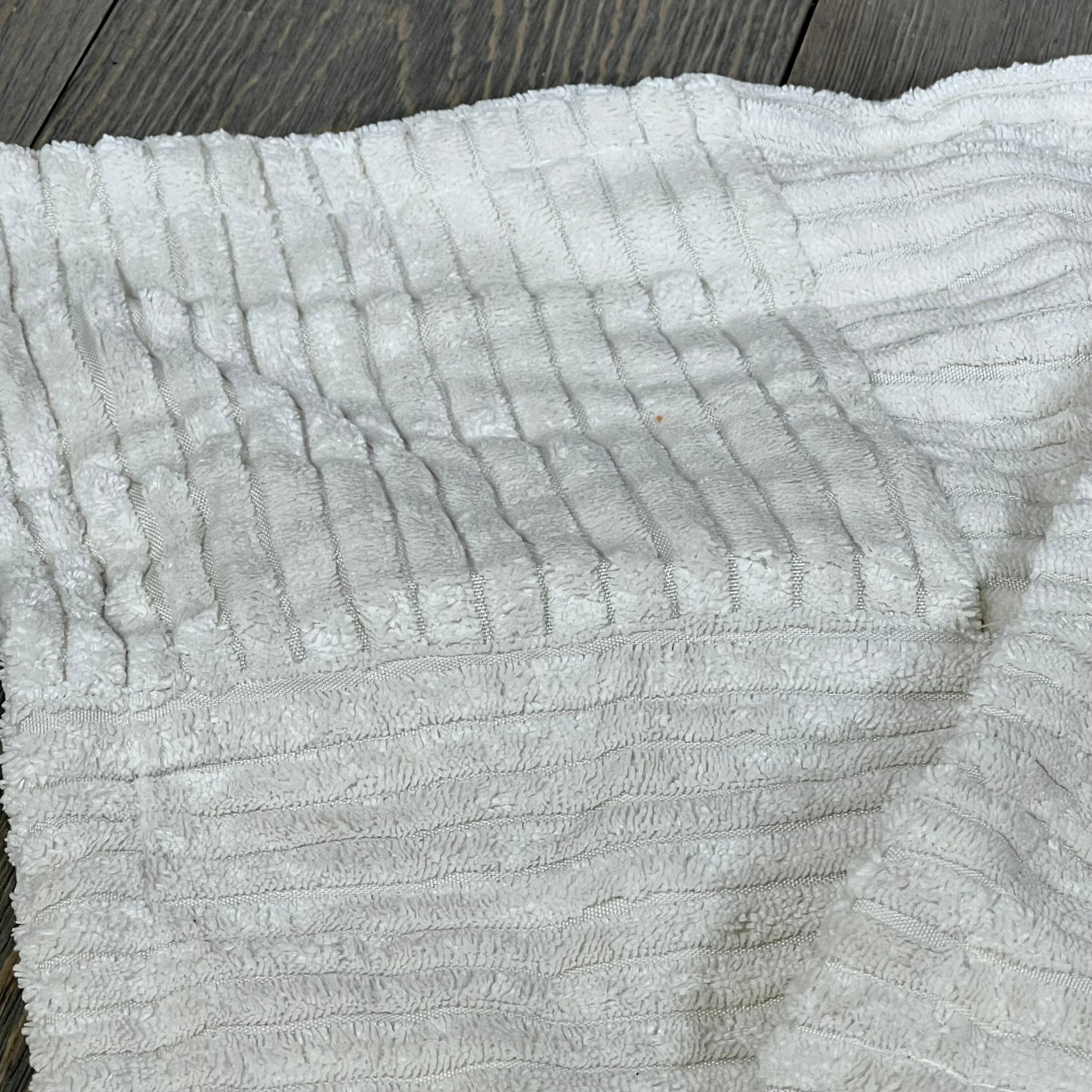 Cream decorative throw pillow cover with soft corduroy fabric, featuring elegant cross patchwork design for farmhouse decor.
