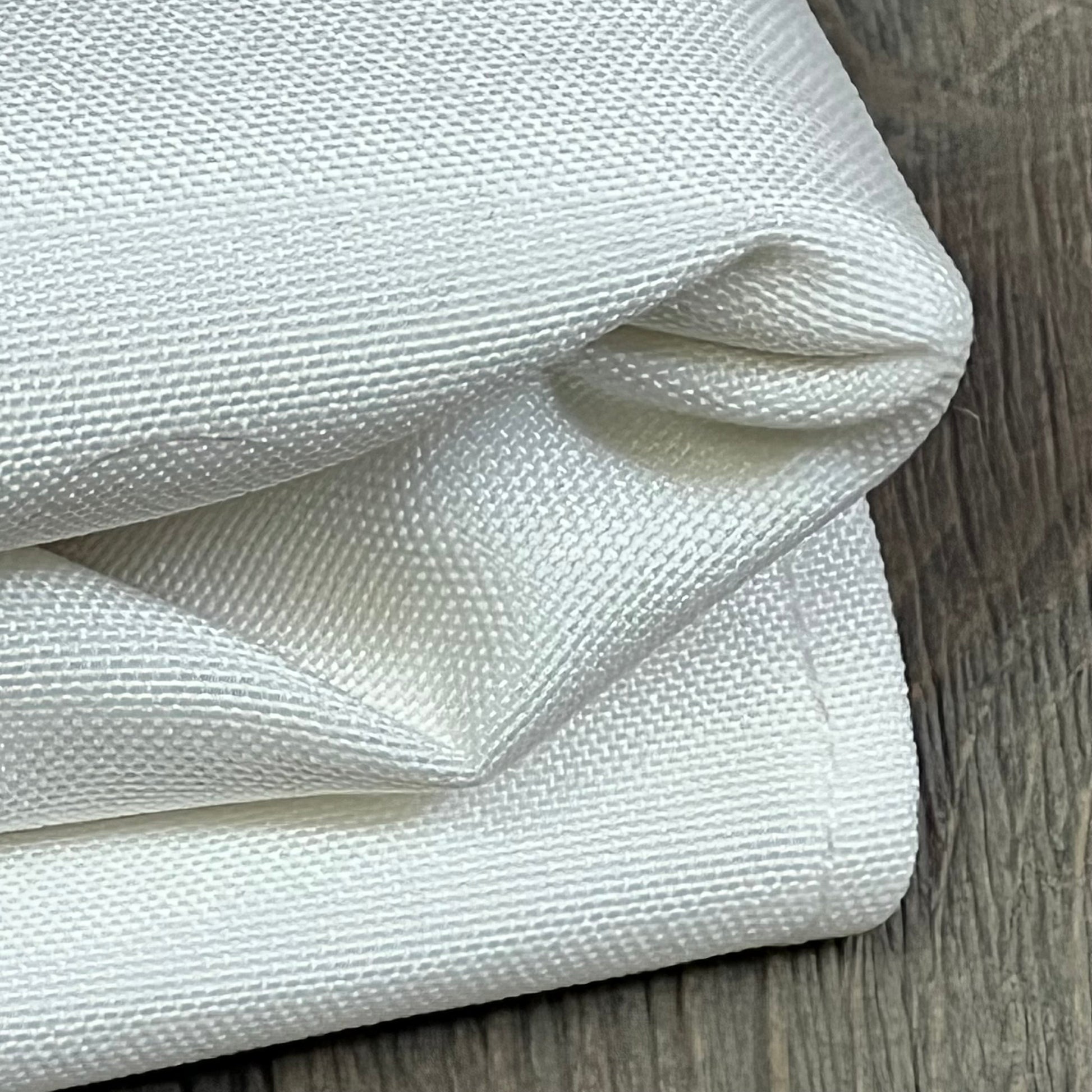 Rustic faux linen tablecloth, close-up of white textured fabric, ideal for kitchen and dining room decor, 60x84 inch.