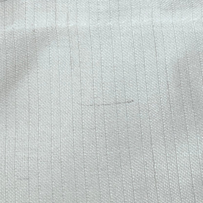 Close-up of white linen blend curtain fabric texture, showcasing light filtering and lightweight quality for farmhouse decor.