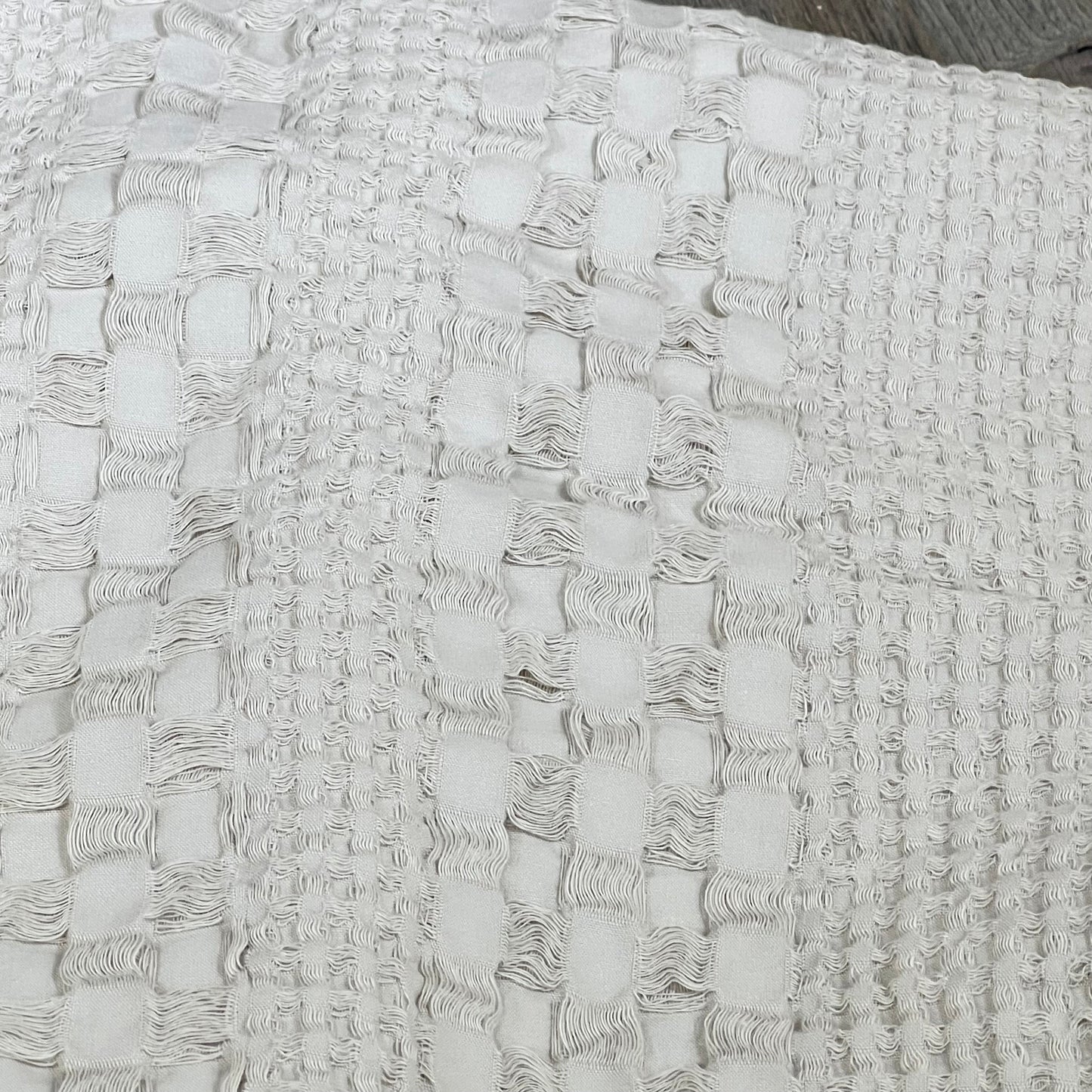 Close-up of oatmeal waffle weave texture on PHF cotton Euro sham cover, highlighting luxurious fabric details.