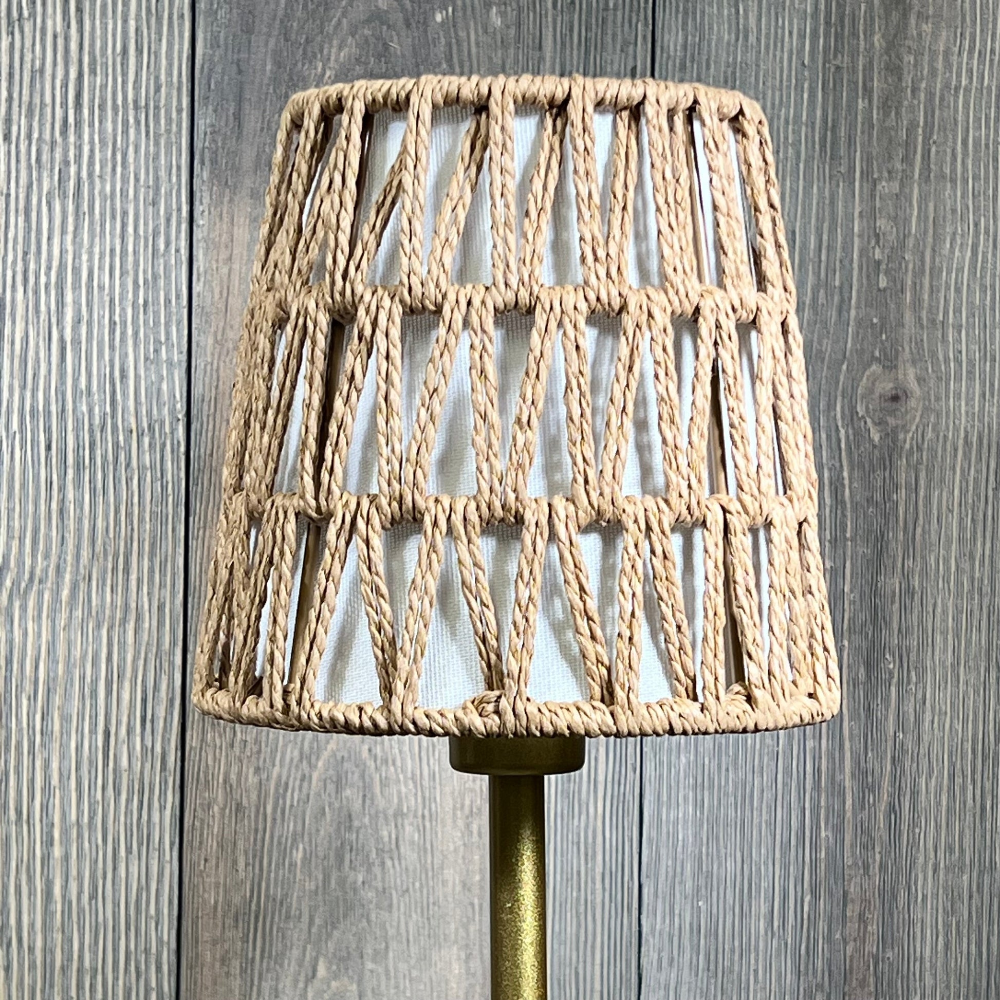 Rattan cordless table lamp with woven shade and gold base, ideal for bedside ambience and stepless dimming features.